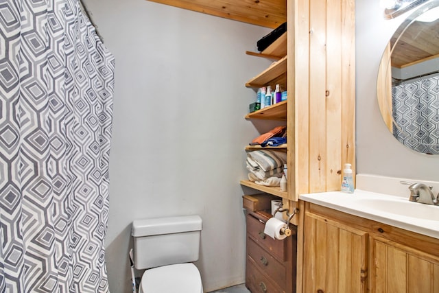 bathroom featuring vanity, toilet, and curtained shower