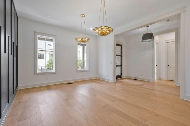 unfurnished room featuring light wood-style flooring and baseboards