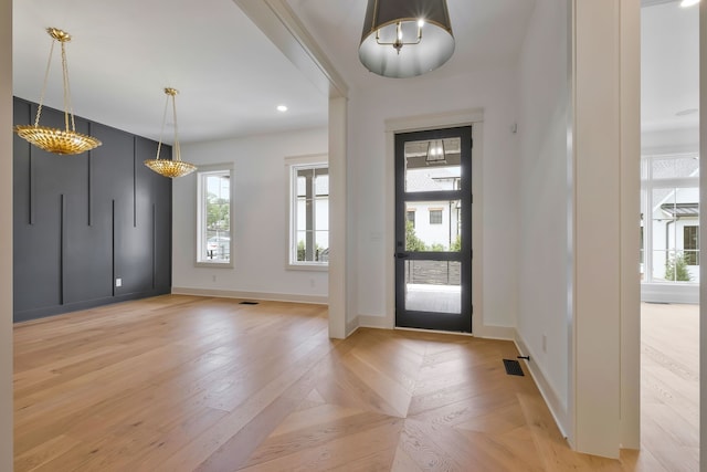 entrance foyer featuring light parquet flooring and plenty of natural light