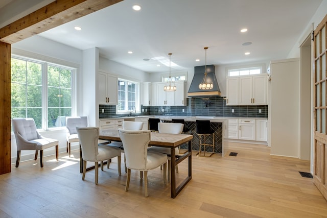 dining area with sink and light hardwood / wood-style flooring