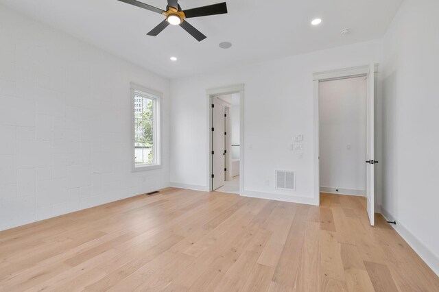 unfurnished bedroom with ceiling fan and light hardwood / wood-style floors