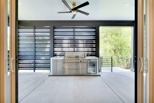 view of patio with ceiling fan, wine cooler, an outdoor kitchen, and grilling area