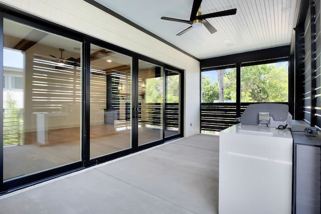 unfurnished sunroom with ceiling fan