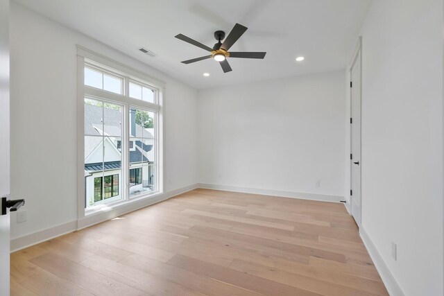 unfurnished room with ceiling fan, light hardwood / wood-style flooring, and a healthy amount of sunlight