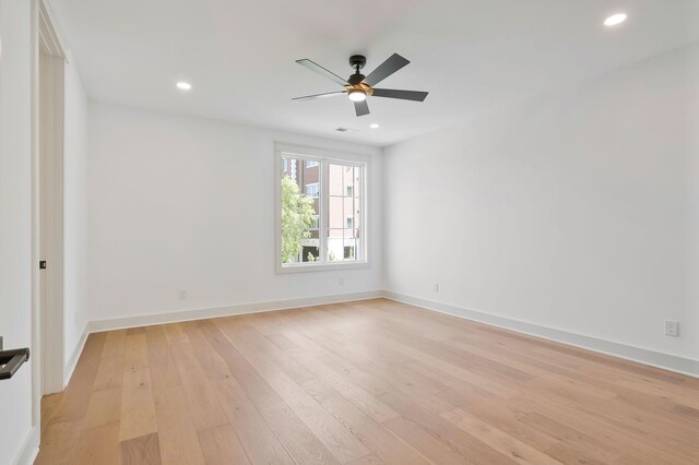 unfurnished room with ceiling fan and light wood-type flooring