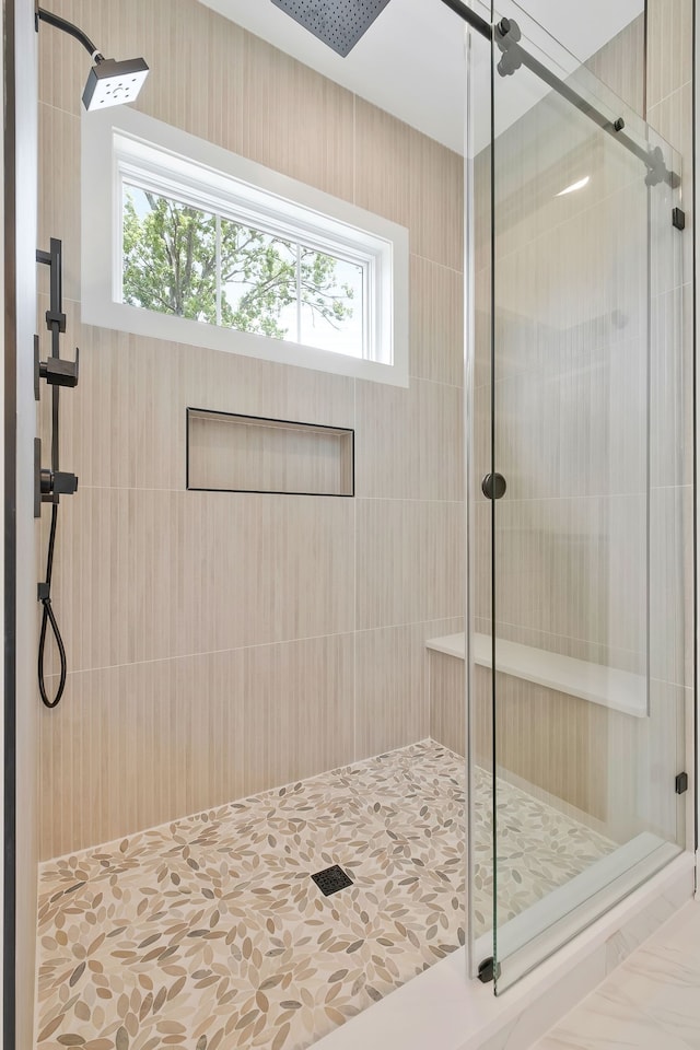 bathroom with tile patterned floors and an enclosed shower