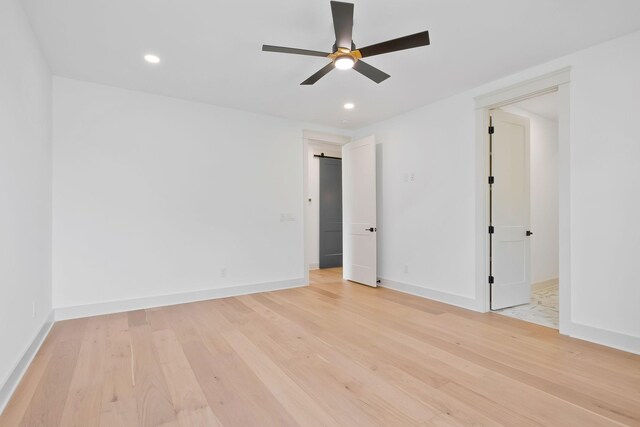 empty room featuring ceiling fan and light hardwood / wood-style flooring