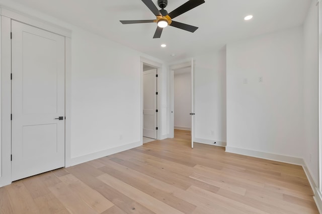 unfurnished bedroom with ceiling fan and light wood-type flooring