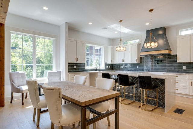 dining area with plenty of natural light and light hardwood / wood-style flooring