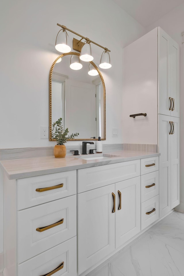 bathroom with marble finish floor and vanity