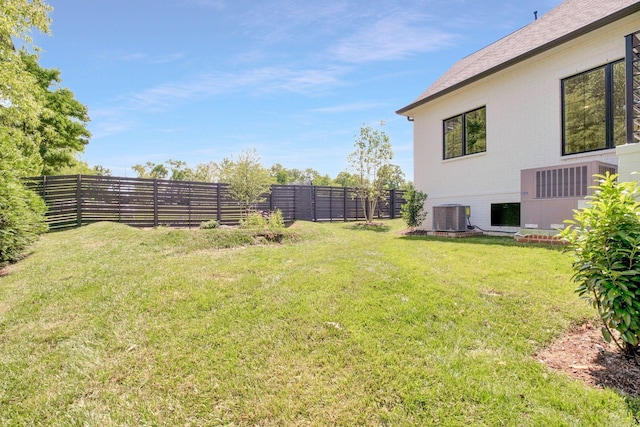 view of yard featuring a fenced backyard and central AC unit