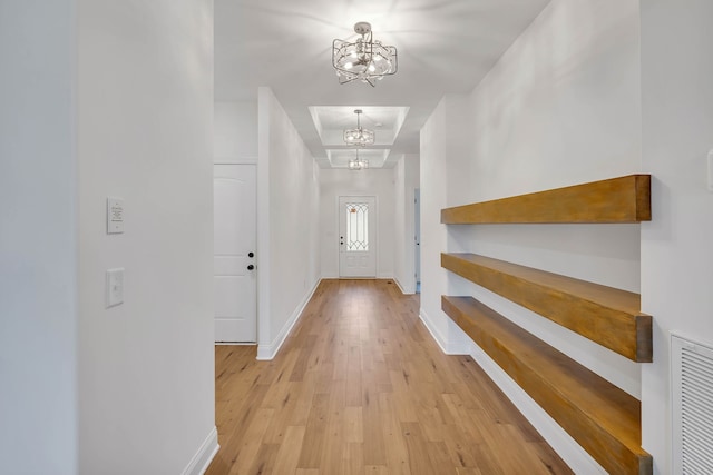 interior space featuring light hardwood / wood-style floors and an inviting chandelier