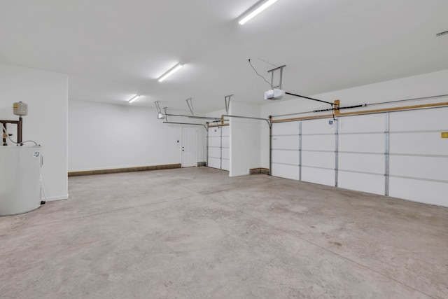 garage featuring a garage door opener and water heater