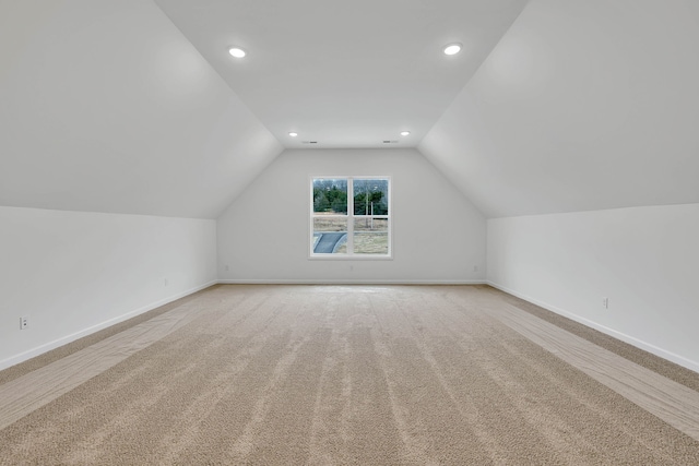 bonus room with carpet and vaulted ceiling