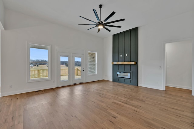 unfurnished living room with light hardwood / wood-style floors and ceiling fan