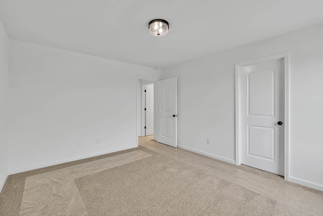 unfurnished room with light carpet