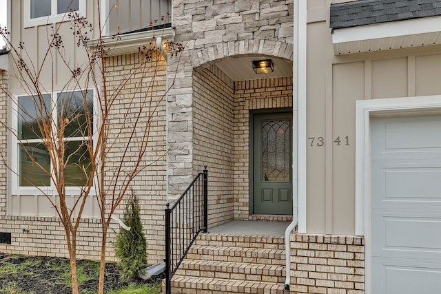 doorway to property with a garage