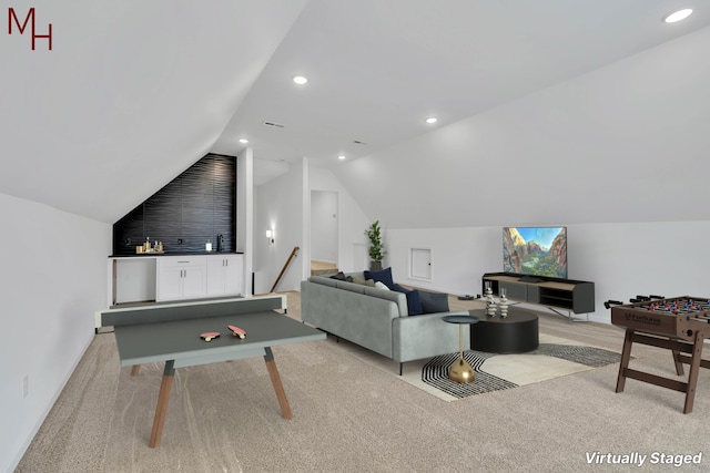 carpeted living room with lofted ceiling