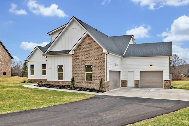 modern inspired farmhouse with a front yard, driveway, an attached garage, board and batten siding, and brick siding