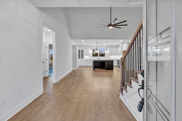 entryway featuring light wood-type flooring and ceiling fan