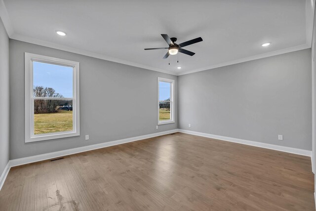 spare room with crown molding, ceiling fan, and wood-type flooring