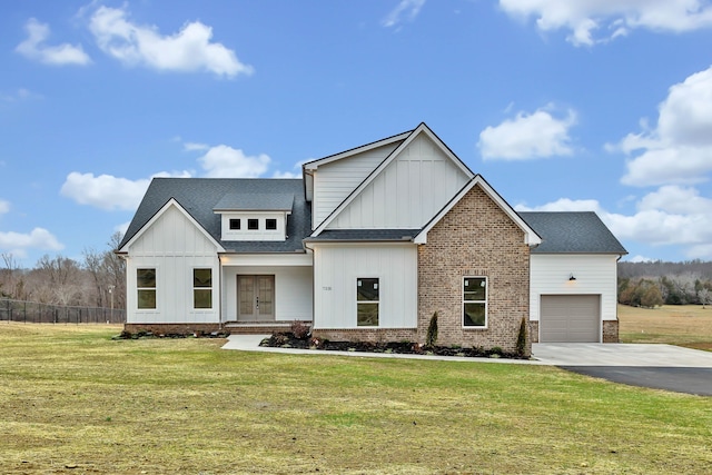 view of front of property with a garage and a front lawn