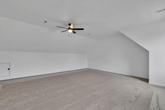 bonus room featuring ceiling fan, light colored carpet, and vaulted ceiling