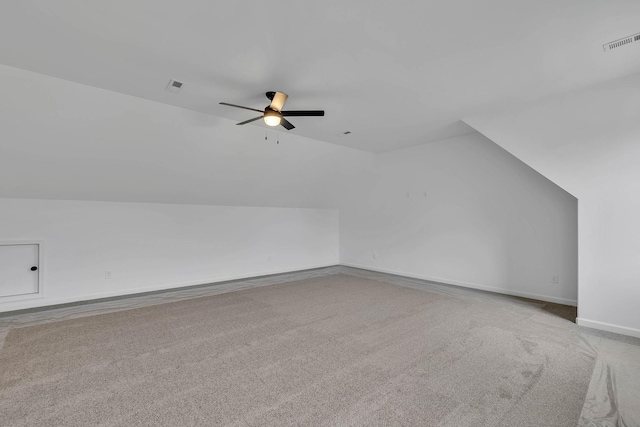 additional living space with visible vents, lofted ceiling, a ceiling fan, and carpet floors