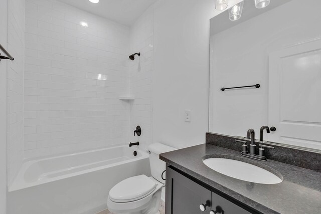 full bathroom with toilet, vanity, and tiled shower / bath