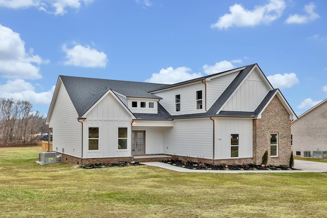 modern farmhouse style home featuring board and batten siding, a shingled roof, a front lawn, central AC, and french doors