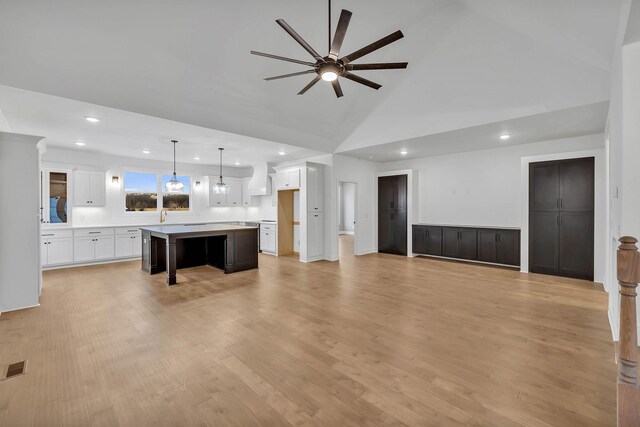 living room with high vaulted ceiling, light hardwood / wood-style flooring, and ceiling fan