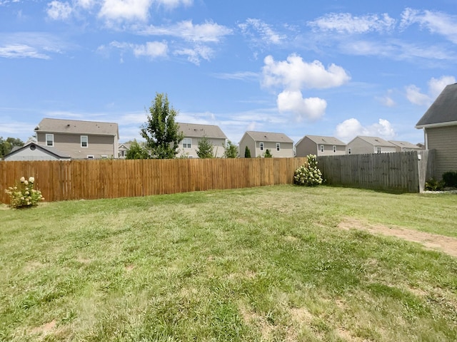 view of yard with a residential view and fence