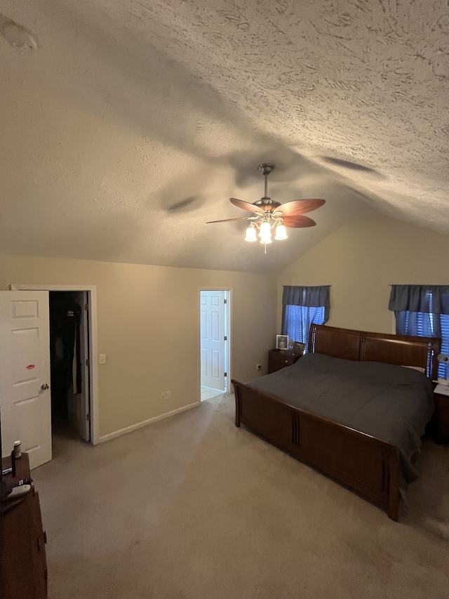 unfurnished bedroom featuring ceiling fan, vaulted ceiling, carpet, and a textured ceiling