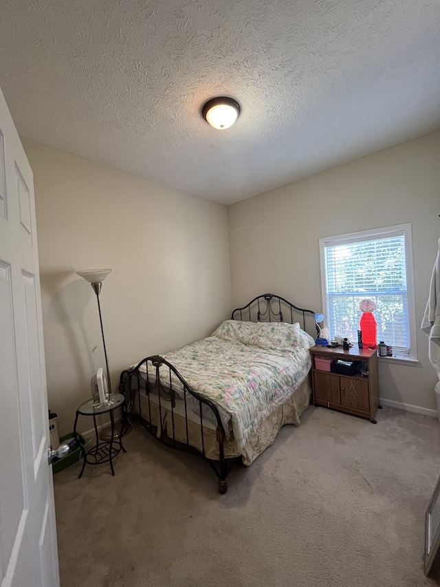 carpeted bedroom with a textured ceiling