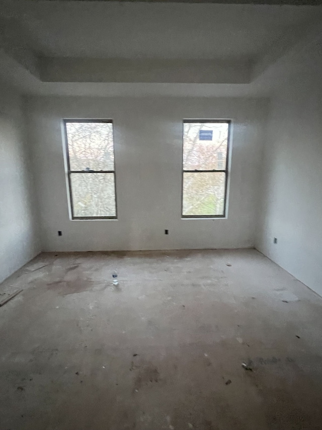 unfurnished room featuring a tray ceiling