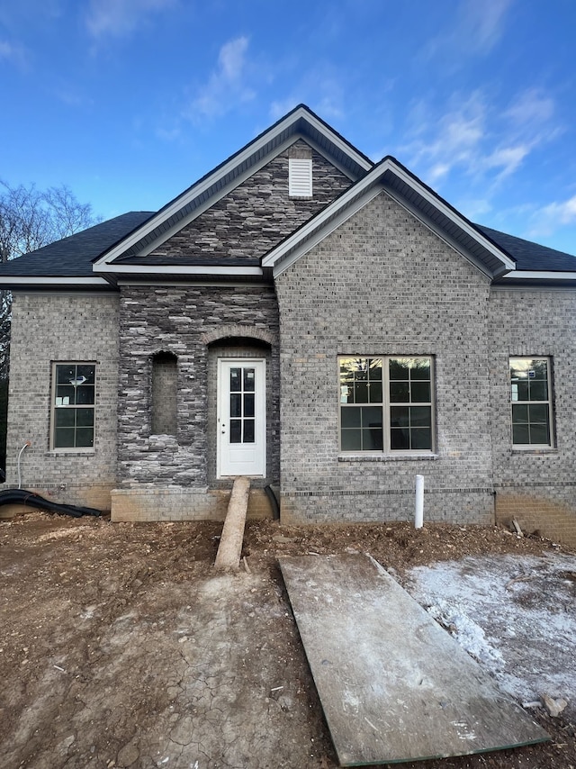 view of front facade with a patio and brick siding