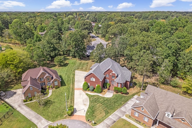 bird's eye view featuring a wooded view and a residential view