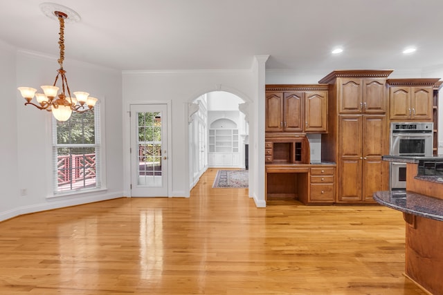 kitchen with hanging light fixtures, light hardwood / wood-style flooring, a notable chandelier, double oven, and ornamental molding