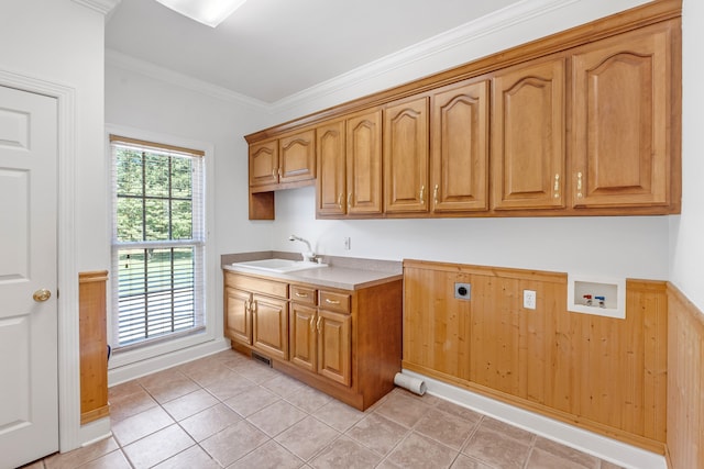 kitchen with light tile patterned floors, light countertops, ornamental molding, brown cabinetry, and a sink