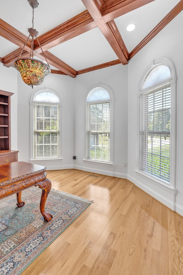 interior space featuring plenty of natural light, light wood-type flooring, and a chandelier