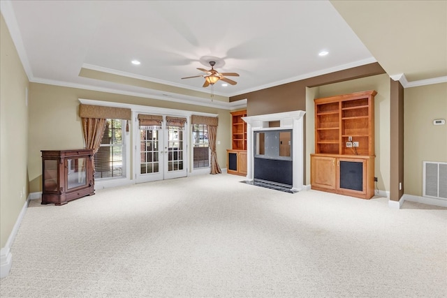 unfurnished living room with ceiling fan, carpet, crown molding, and french doors