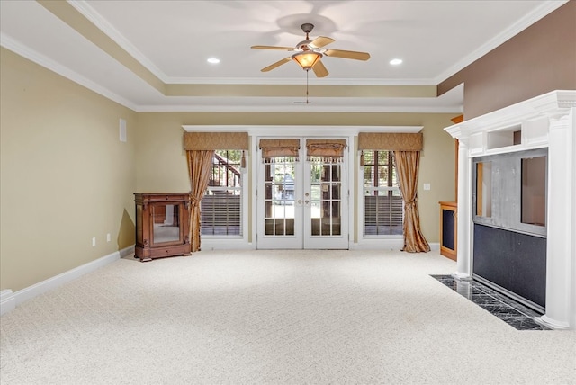 unfurnished living room with ceiling fan, carpet floors, crown molding, and a healthy amount of sunlight