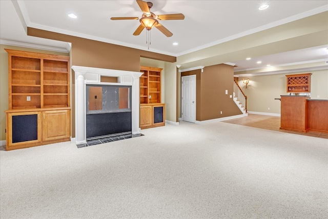 unfurnished living room featuring baseboards, stairway, crown molding, and light colored carpet