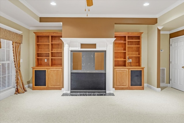 unfurnished living room featuring ceiling fan, carpet floors, and ornamental molding