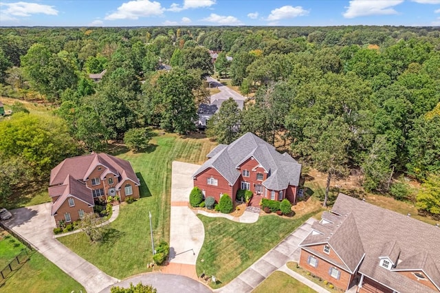 bird's eye view with a wooded view and a residential view