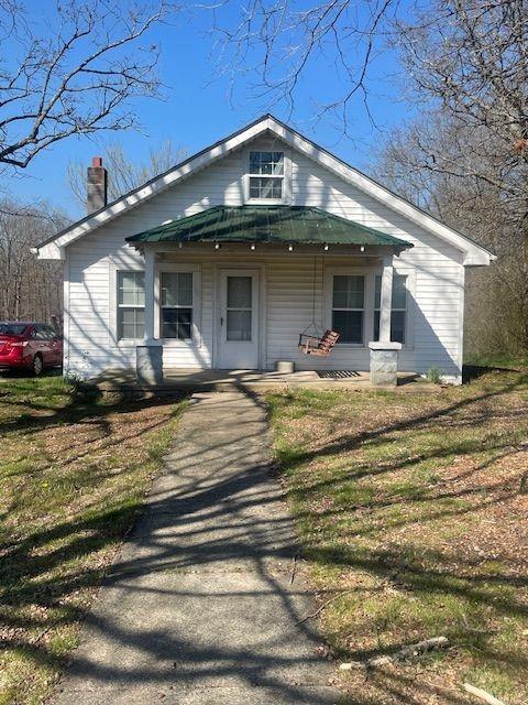 view of front facade featuring covered porch and a front lawn