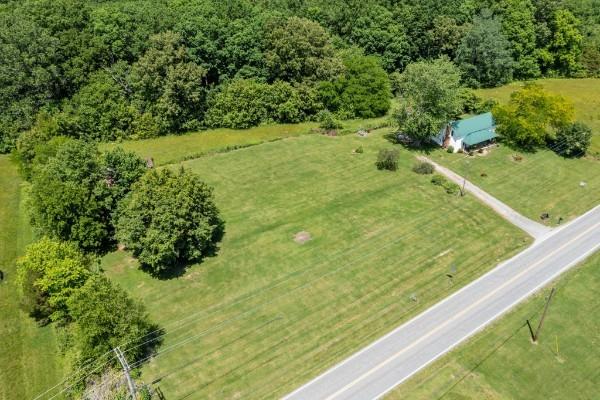 birds eye view of property with a rural view