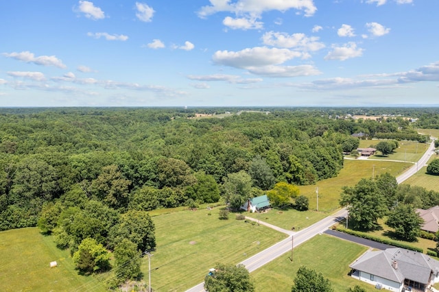 birds eye view of property featuring a view of trees and a rural view