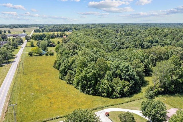 drone / aerial view with a wooded view