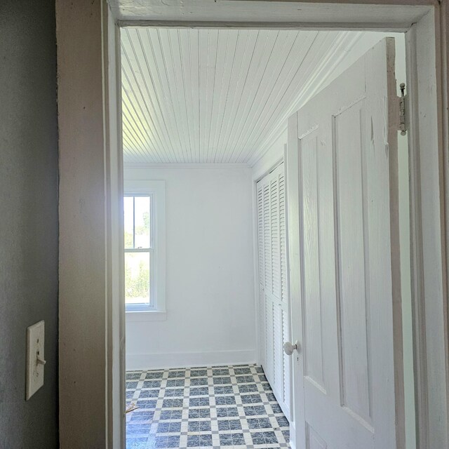 hallway with tile patterned floors